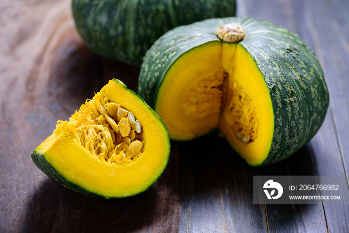 Green pumpkins on wooden background, organic vegetable