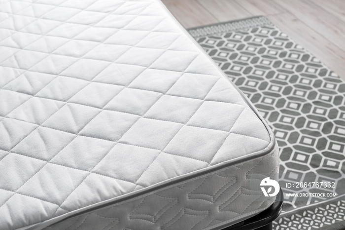 Modern orthopedic mattress on bed in room