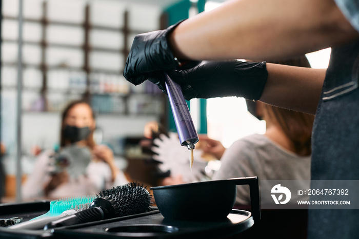 Close-up of hairdresser prepares color for hair dyeing at the salon.