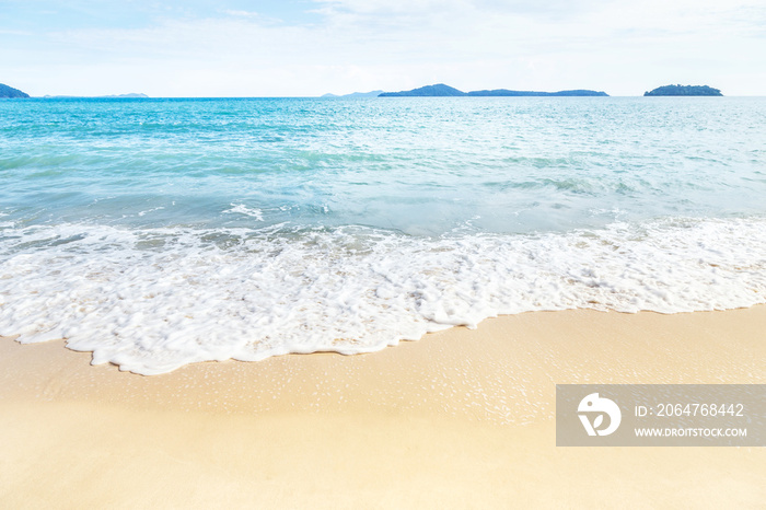 white soft wave rolling splash on empty tropical sandy beach in sunny day