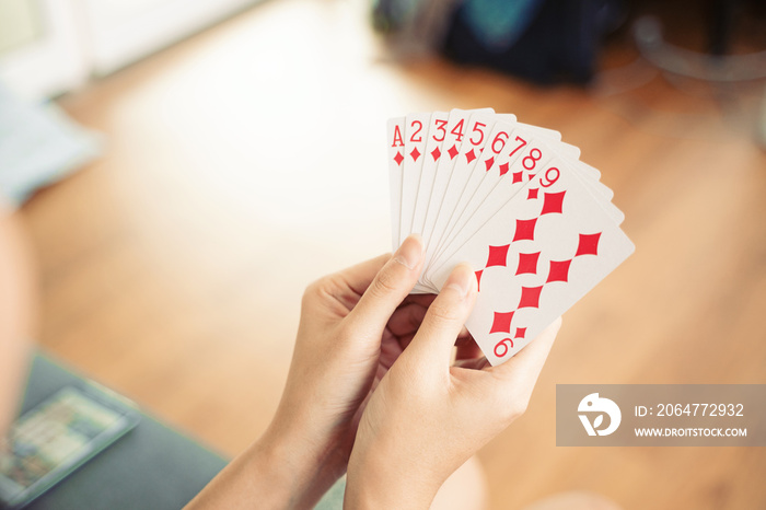 Asian women playing cards at home.