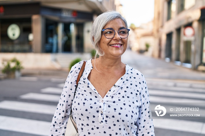 Middle age woman smiling confident standing at street