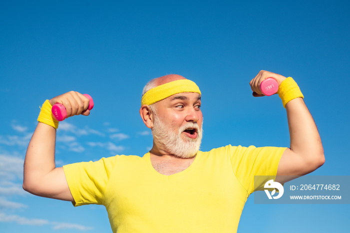 Portrait of senior man holding dumbbell. Like sports. Portrait of healthy happy smile senior. Grandf