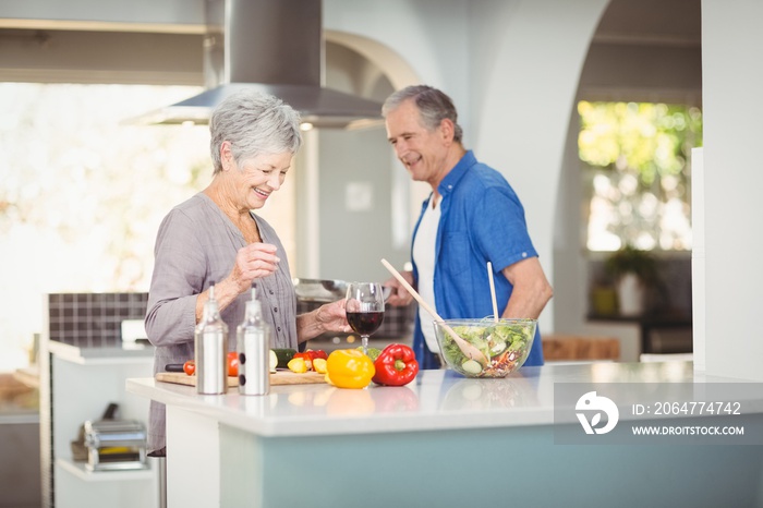 Cheerful senior couple at kitchen counter