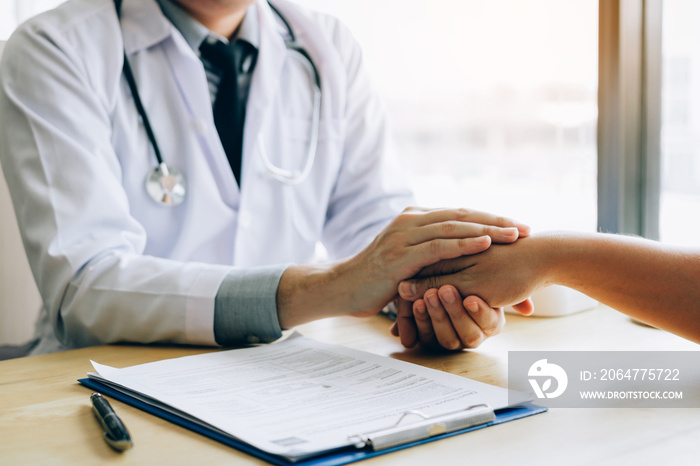 Doctor holds hands and leaves comforting counselors to patient.