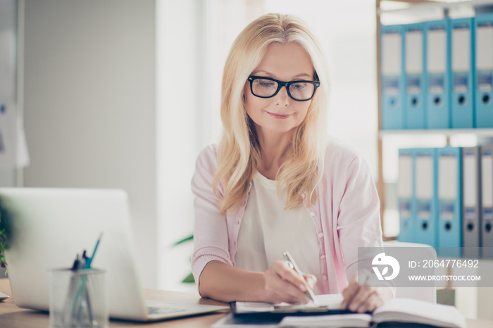 Pretty, nice, cute, confident accountant holding pen in hand, making notes on paper in clip board, s