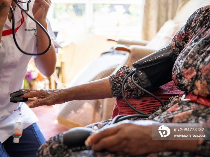 Nurse�taking care of elderly woman, measuring oxygen saturation