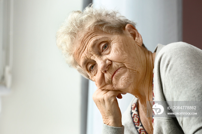 Portrait of depressed senior woman at home