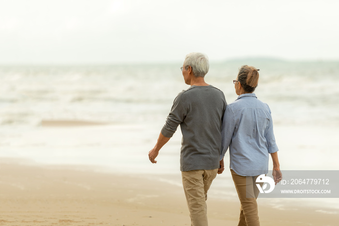 Asian Lifestyle senior couple walking chill on the beach happy in love romantic and relax time.  Peo