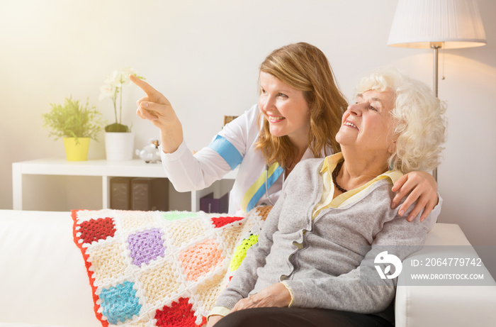 Grandma and health proffessional looking at something