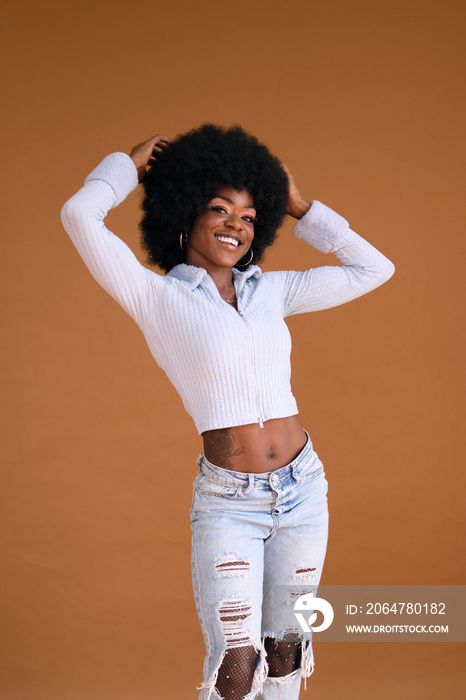 Studio portrait of young beautiful women with afro hair smiling