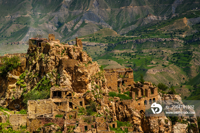 Ruins of the ancient village of Gamsutl with abandoned stone walls of a building on top of a mountai