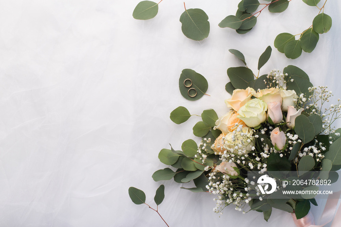 Wedding bouquet of beautiful cream roses on white background