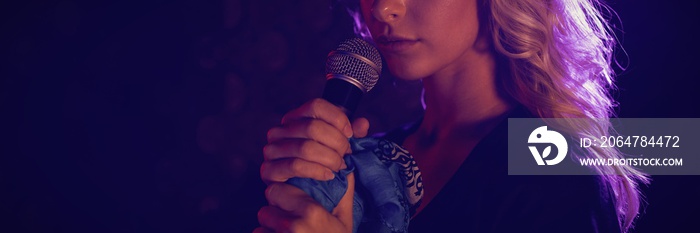 Close up of beautiful female singer with microphone