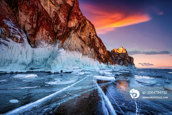 Landscape of Mountain at sunset with natural breaking ice in frozen water on Lake Baikal, Siberia, R