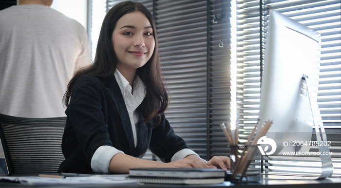 A young female administrative assistant making notes of working planning organizing information in h