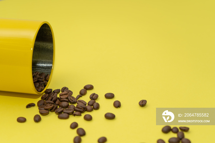 Coffee beans scattered from the yellow can