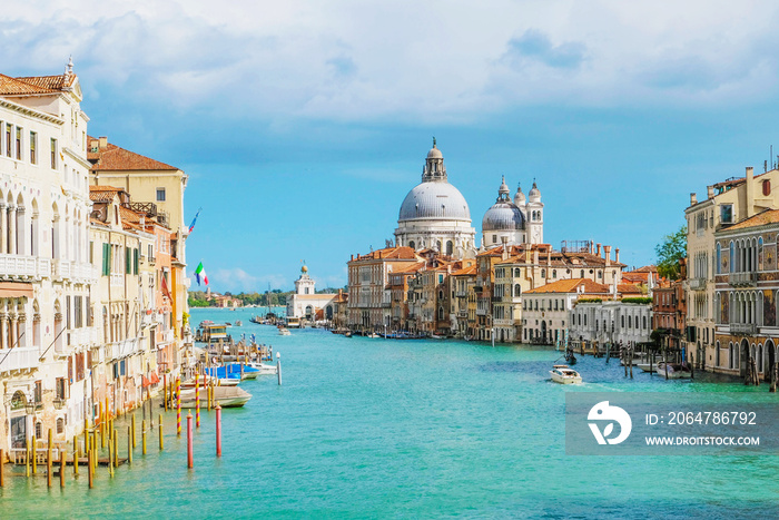 View of Venice Grand Canal with Saint Mary of Health dome on sunny day.