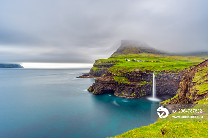 Gasadalur waterfall long exposure in Faroe Islands, misty day