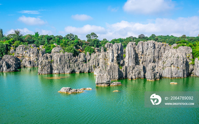 Limestone rock formation over beautiful lake and blue sky at Shilin stone forest park Yunnan China