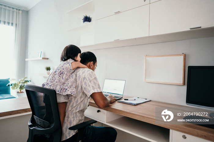 young business man parent interrupts by her daughter while working in the office