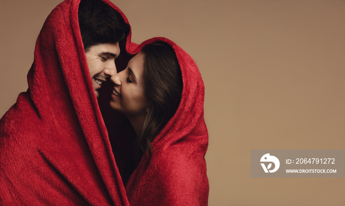 Couple in love wrapped in a blanket