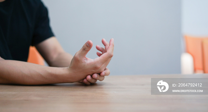 close up employee man massage on his hand and arm for relief pain from hard working ,carpal tunnel s