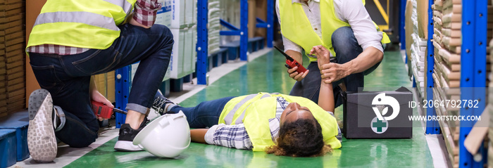 Warehouse worker frist aid after accident panoramic.