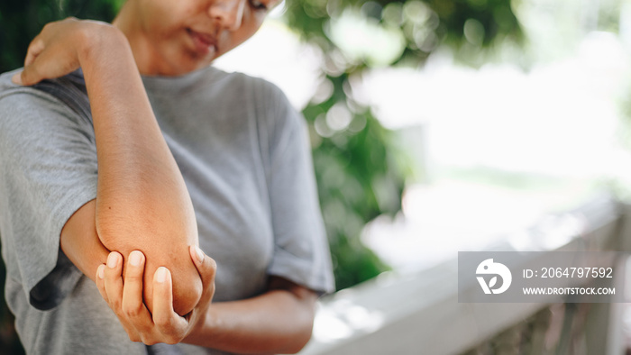 Pain in elbow , Asian young women with elbow pain, health care concepts, Health Care Concept