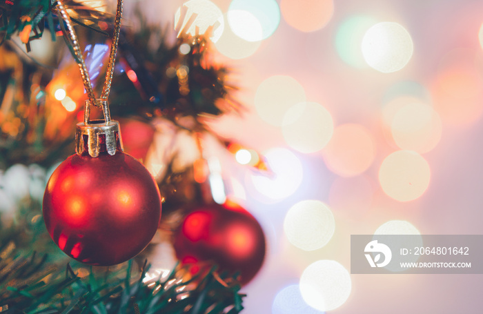 Christmas decoration. Red balls hanging on pine branches Christmas tree garland and ornaments over a