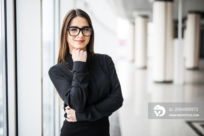 Business woman against a window.