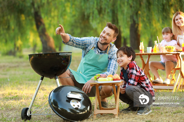 Father with son having picnic on summer day