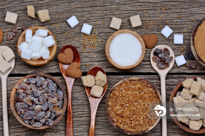 Variation sugar in a bowls and spoons on table