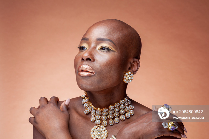 Portrait of woman with golden make-up and jewelry