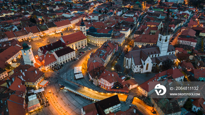 Birds eye view over historic city center of Sibiu, Romania at sunset. Drone photography from above c