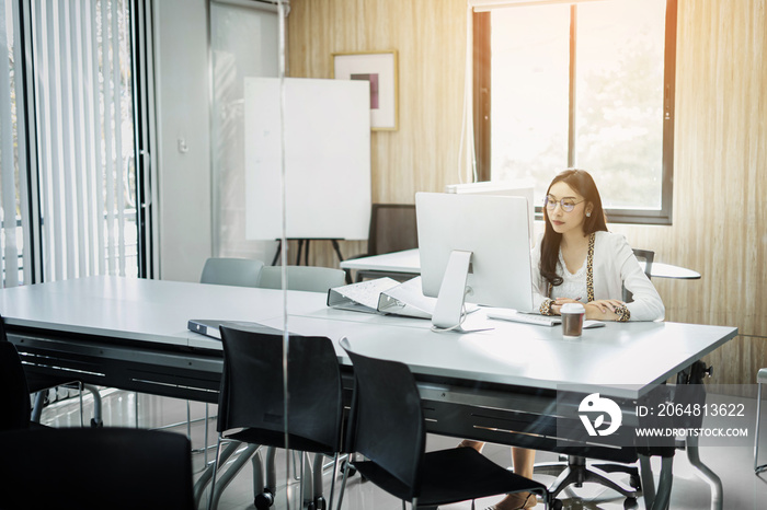 Concentrated young businesswoman working on her computer in the office.,sitting on workplace.,Happy 