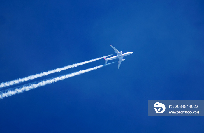 Trace of the high flying plane in the clear blue sky.