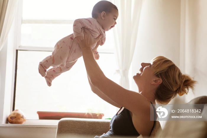 Mother playing with daughter (2-5 months)