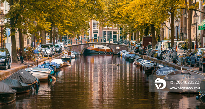 canal and boats in Amsterdam on an autumn day