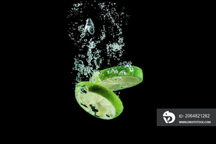 lime under water with splashes on a black background