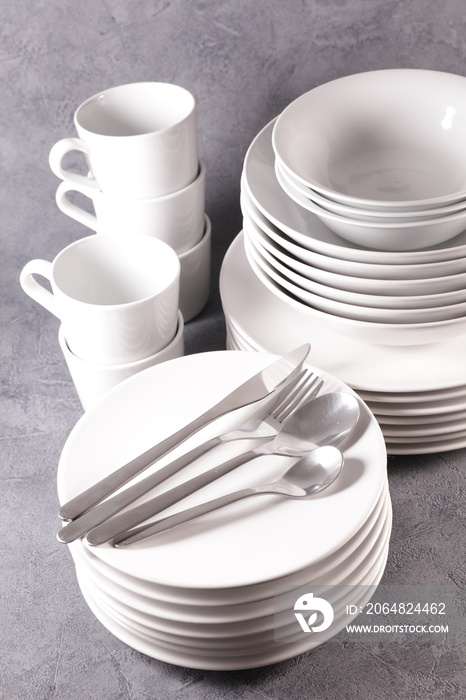 pile of plates empty with mug and bowl isolated on white background