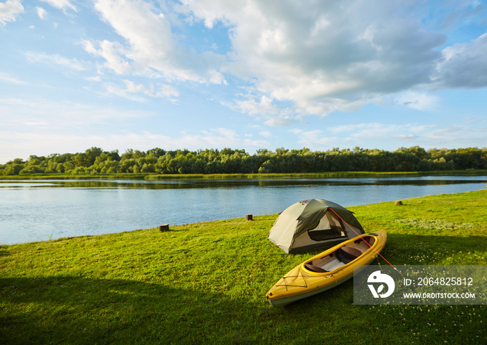 Rafting on kayak. A tent stands on the river bank.