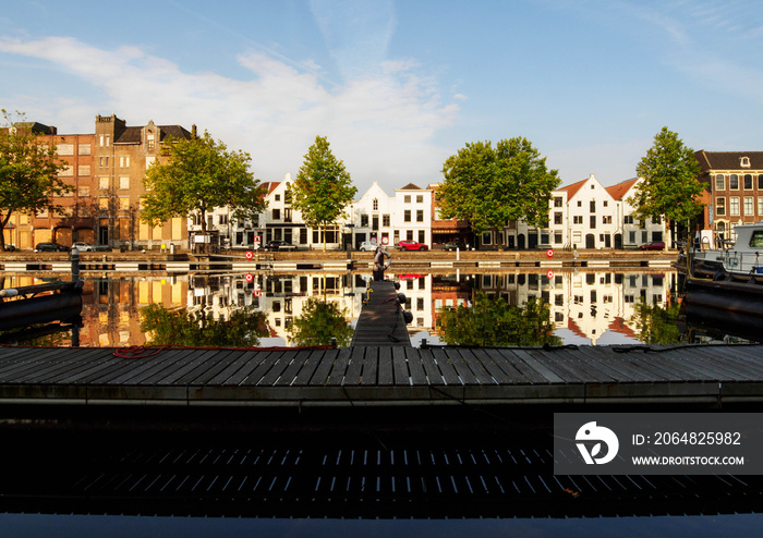 View of the canal with boats and beautiful buildings of Vlaardingen (