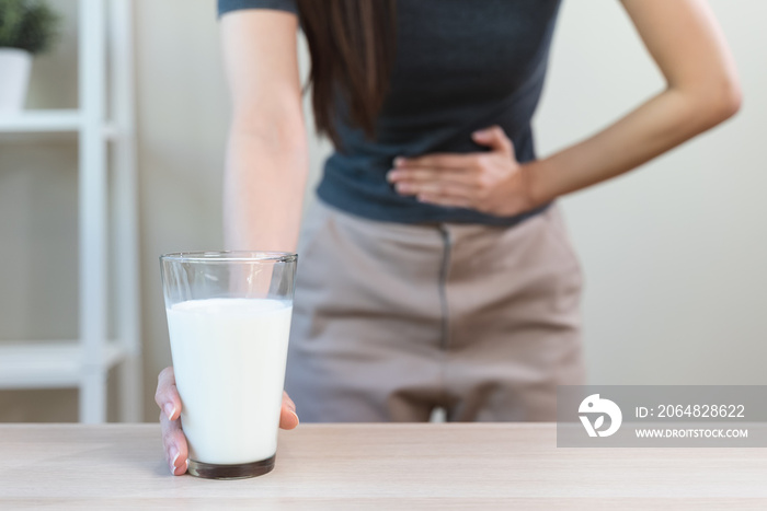 lactose intolerance concept. Woman having a stomachache because drink milk.