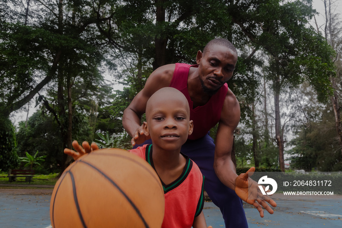 Father attempting to stop the ball from son