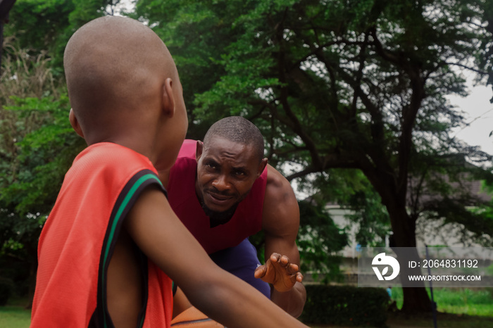 Father being patient with son at basketball training