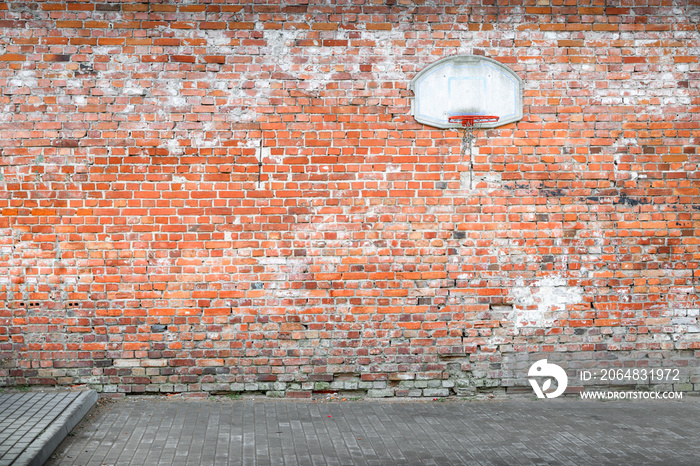 Basketball court by a brick wall in Poland.