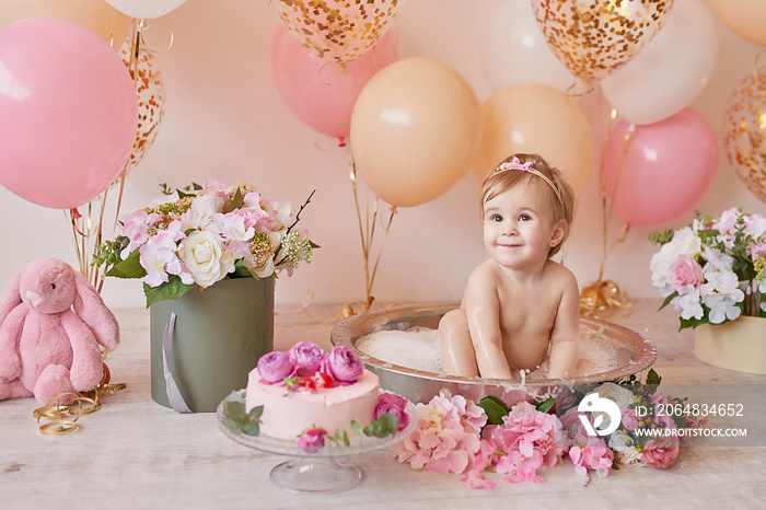 Smash cake party. Little cheerful birthday girl with first cake. Happy infant baby celebrating his f