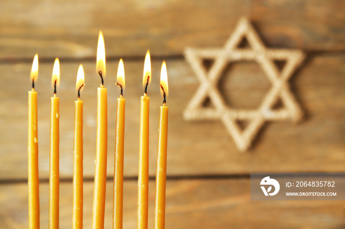 Hanukkah candle on wooden background