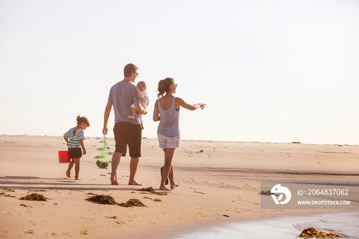 Family with two children (0-1 month, 2-3 years) on beach